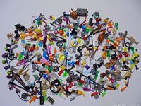 Full spread of assorted LEGO minifigure accessories on white background
