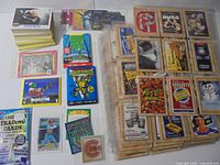 Overview showing sealed TMNT packs, Hershey sheets, Batman stacks, assorted sports cards