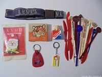 Group shot of belt, keychains, boxes, Avon pack and swizzle sticks