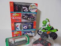 Group shot showing all items: Yoshi RC ATV, two SnapTite model kits, Hess truck