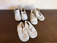 Top view all three pairs of antique children’s shoes