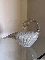 Side profile of clear and white art glass swan