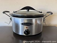 Front view of Hamilton Beach stainless steel slow cooker with lid and control knob visible