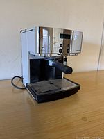 Front-left view of Nespresso Type D300 espresso machine showing control panel, portafilter and drip tray