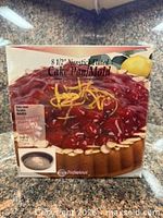 Front of Norpro nonstick fluted cake pan box showing product image and size