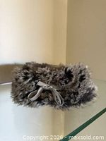 Top view of faux fur pouch showing circular shape and ribbon tie