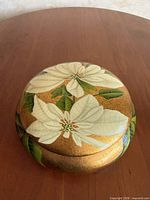 Top view of jar showing floral design on lid