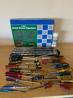 Full lot overview showing boxed organizer, socket rails, screwdrivers, hex keys, aerosol can