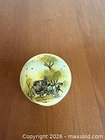 Top view of round box showing horse and buggy scene