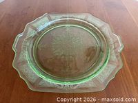 Full view of green Princess pattern salad plate on wood surface
