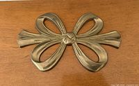 Overhead view of full brass bow trivet