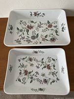 Two rectangular floral ceramic bakers on table