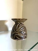 Side view showing floral relief and glaze finish