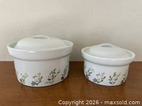 Front view of both lidded dishes showing floral pattern and relative sizes