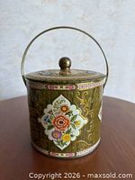 Front view of floral metal canister showing main pattern and lid