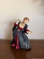 Front view of figurine highlighting dress colors and pose