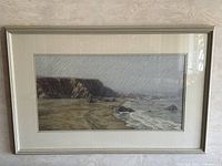 Front view of framed coastal landscape artwork in metallic wood frame
