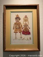 Full view of framed pressed flower artwork in wood frame