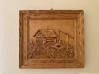 Front view of framed wood carving art