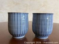 Two striped porcelain cups side by side