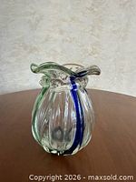 Front view of clear lobed vase showing blue and green stripes