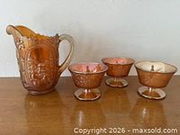 Pitcher and three sherbet glasses on table