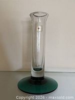 Full view of clear glass candlestick holder with green base showing proportions and overall condition