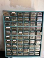 Full view of teal cabinet with all drawers visible