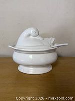 Front view of white Pfaltzgraff duck soup tureen with lid and ladle