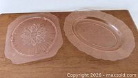 Both pink Depression glass platters side by side
