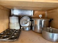 Overview of all cookware and bakeware inside cabinet