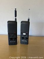Front view of both Realistic RadioShack handheld walkie-talkies showing speaker grilles, control knobs, and antennas