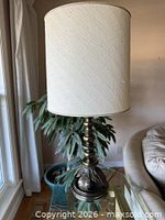 Whole lamp with shade on glass table