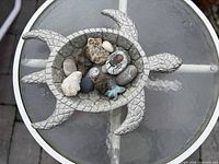 Top view of stone turtle bowl filled with assorted stones