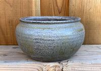 Front view of textured stoneware planter pot showing glaze and form
