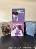 Front view showing four LP jackets: Righteous Brothers, Elton John, Esquivel, sealed blue Esther album