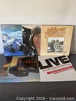 Group shot of four vinyl albums showing all covers