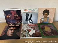 All six LPs standing on a table showing front jackets