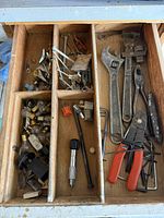 Drawer with assorted wrenches, wire stripper, hex keys, bulbs, connectors and hardware