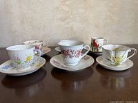 Group shot of six teacup and saucer pairs on tabletop