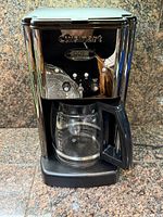 Front view of Cuisinart drip coffee maker showing control panel, carafe, and exterior condition
