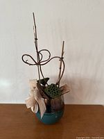 Full view of faux floral arrangement in two-tone vase