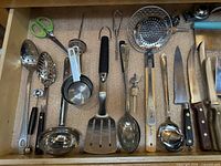Full view of drawer with utensils and knives