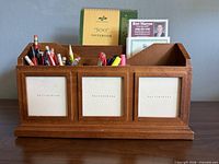 Front view showing organizer compartments and photo-frame panels