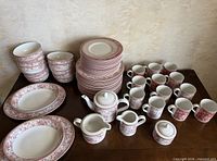 Full set showing stacks of plates, bowls, mugs, teapot, creamer, sugar and platters