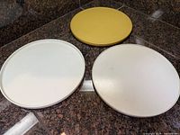 Top view of three round turntables in white and yellow