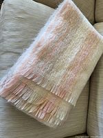 Folded fuzzy throw blanket showing overall appearance and fringe