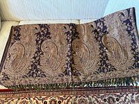 Full view of woven paisley pashmina scarf showing pattern, border and fringe