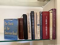 Shelf with ten books showing spines, titles visible