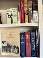 Full view of shelf showing top row of seven presidential biographies and other titles